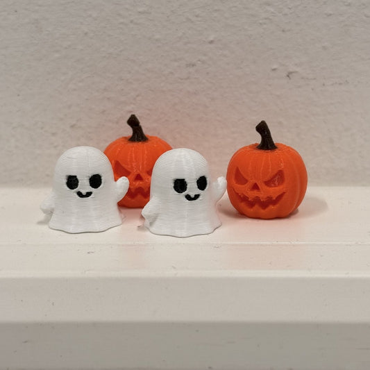 Ghost and pumpkin valve caps together